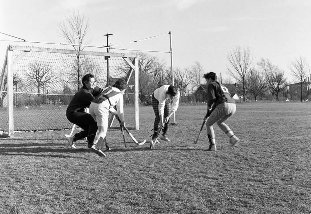 Women playing field hockey, circa 1950s