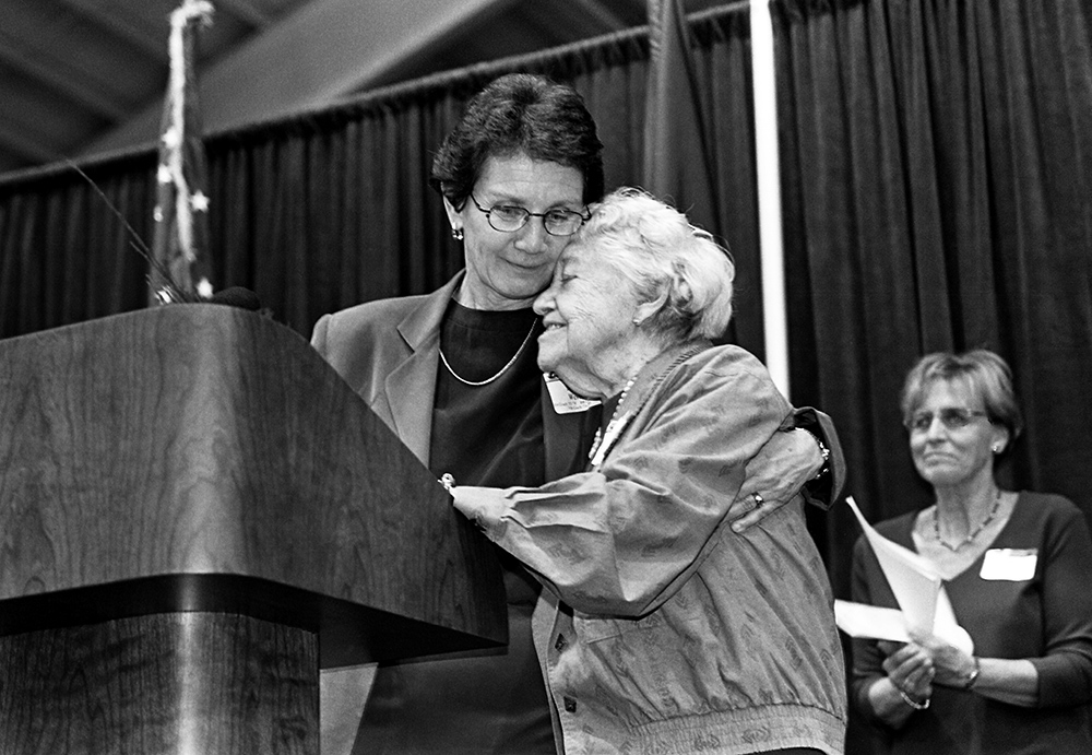 Women embrace at the 2000 Varsity Letter ceremony